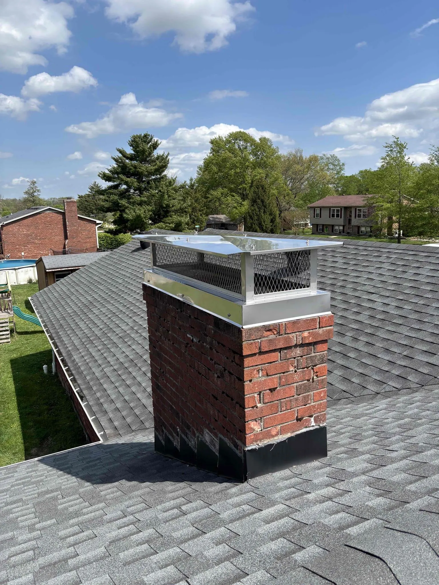 Stainless steel chimney cap installed on a brick chimney by Barnhill Chimney in Lexington, KY