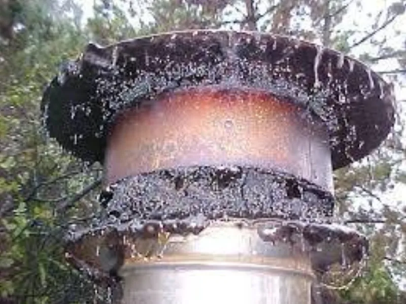 Chimney cap clogged with creosote buildup