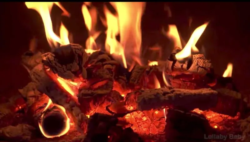 Warm fire burning in a fireplace, illustrating the relaxing health benefits of watching a fire