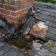 Water stains and damaged flashing near a chimney