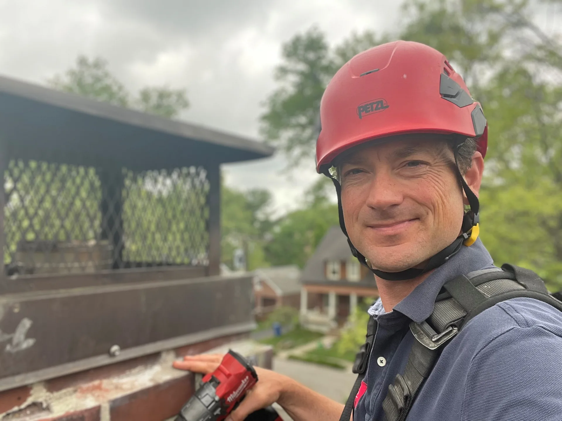 Brion Barnhill inspecting a chimney chase cover on a Lexington, KY rooftop