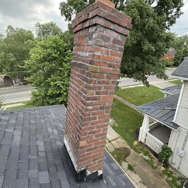 Severely leaning brick chimney pulling away from a Lexington, KY home
