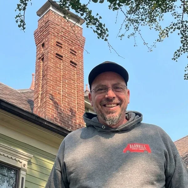 Barnhill technician beside a restored brick chimney in Lexington, KY