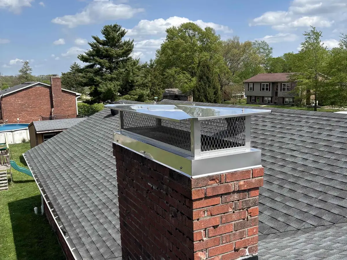 Stainless steel chimney cap on a brick chimney in Lexington, KY